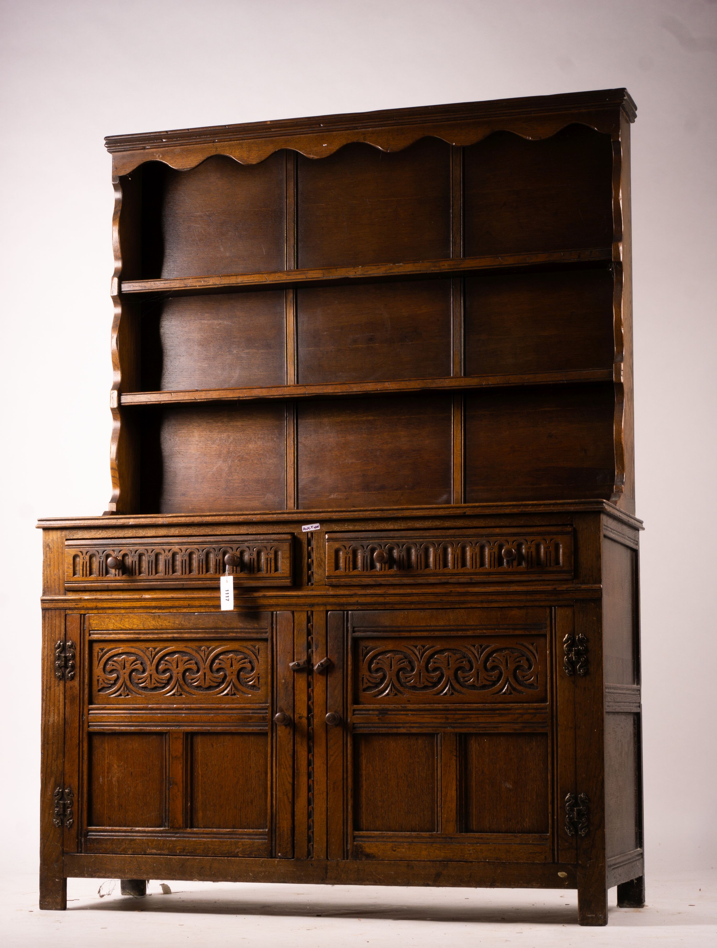 An 18th century style carved oak dresser, width 124cm, depth 46cm, height 175cm